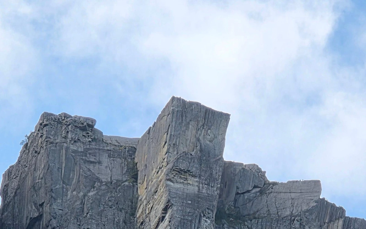 The sheer grey block of Pulpit Rock seen from the fjord below