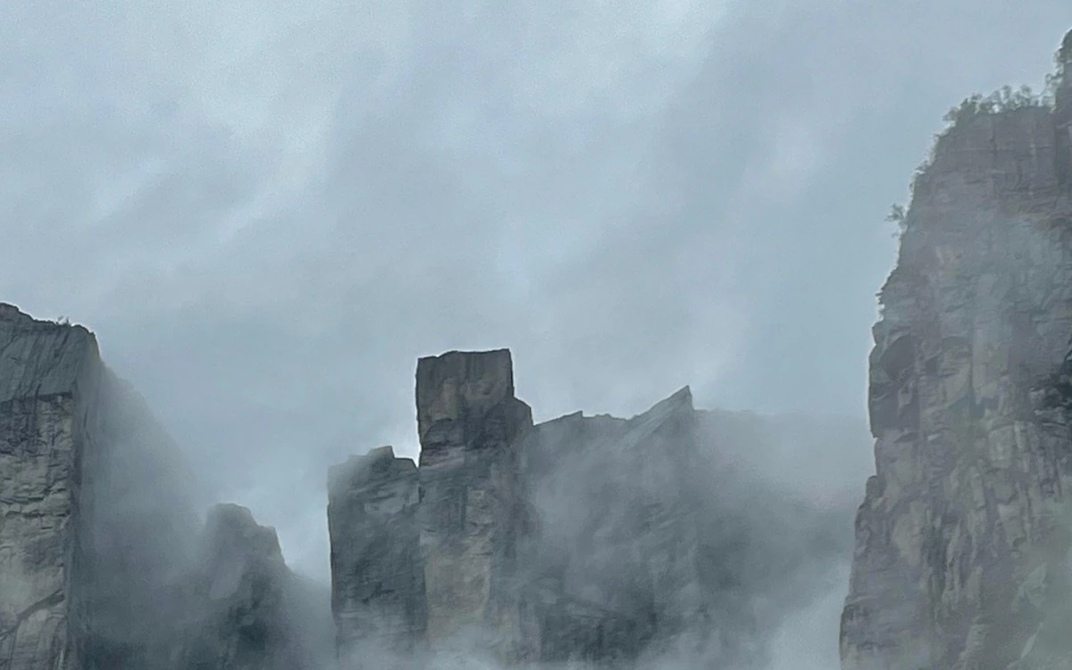 Pulpit Rock half hidden by mist drifting across the cliffs